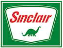 A logo with a green background over a white, five-sided shape. Over that is the word 'Sinclair' in red over a green dinosaur.